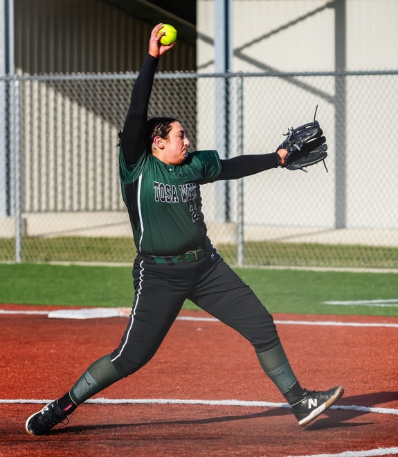 Wauwatosa West's Mia Weithaus (22) delivers a pitch during the game at home against Wauwatosa East, Thursday, March 21, 2024.