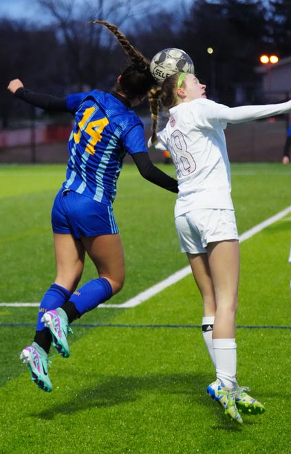 Catholic Memorial's Claire Weber (14) battles for a header with Divine Savior Holy Angels' Avery Roethe (18) during the match at Mindiola Park in Waukesha, Tuesday, March 26, 2024.